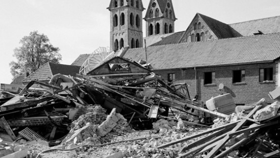 Überreste eines Hauses mit Kirchtürmen im Hintergrund