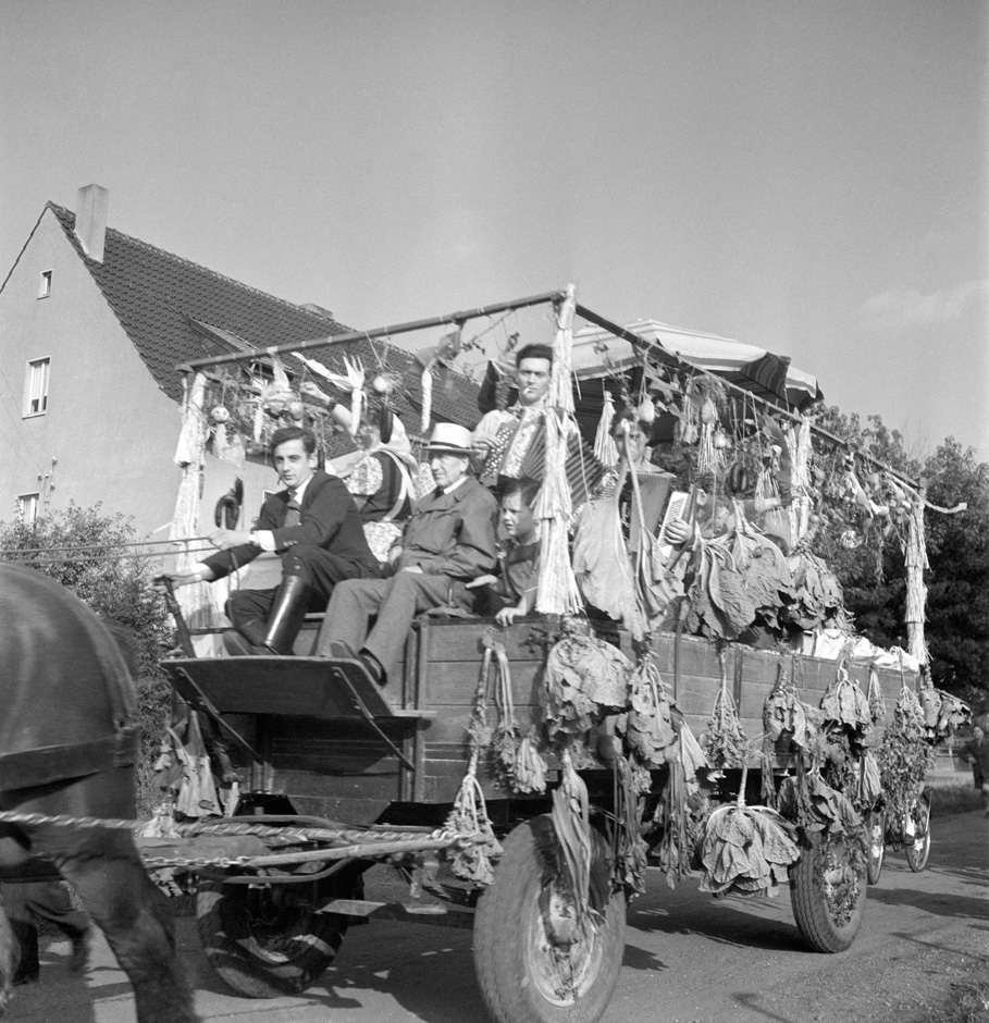 Ein Wagen fährt durch ein Dorf.