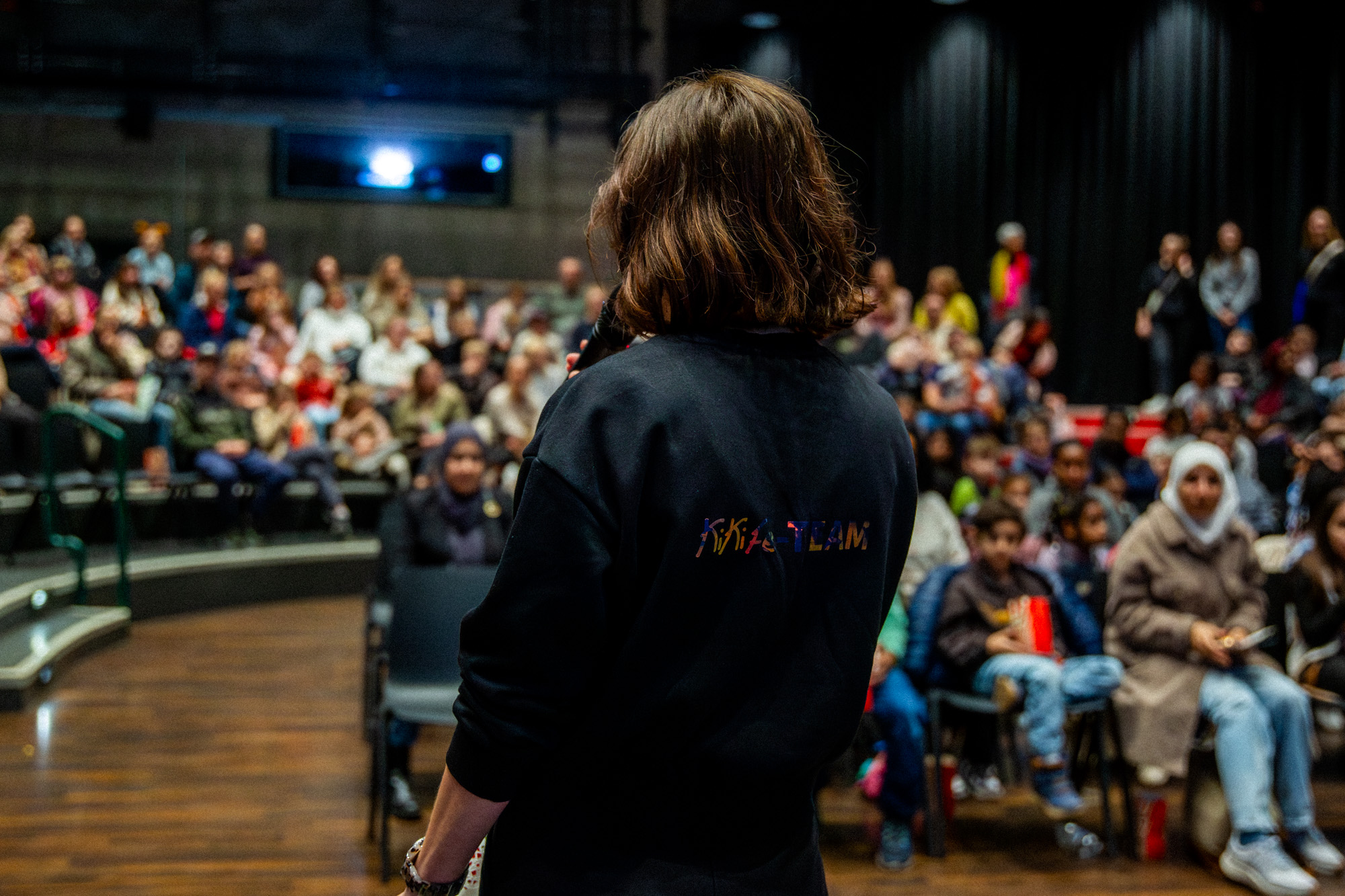 Moderatorin vor Publikum im Kinosaal.